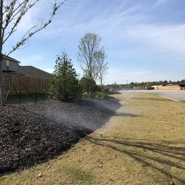 Sprinklers watering newly laid sod at a new home