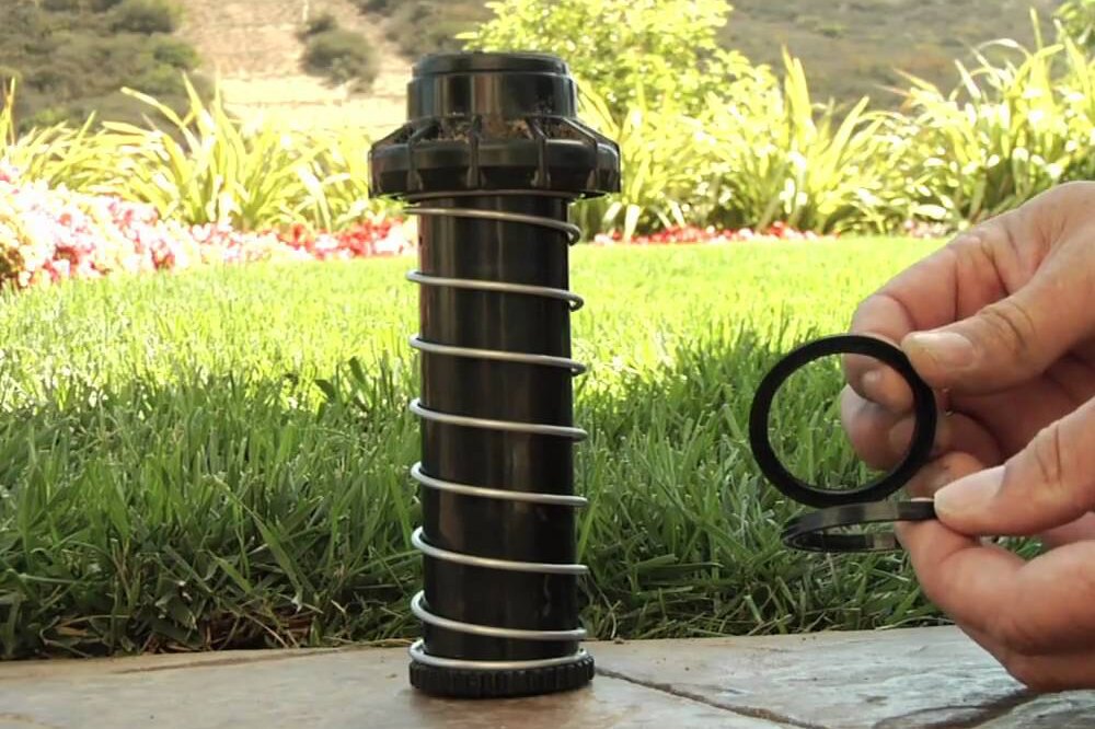 Technician replacing a pop-up sprinkler head seal